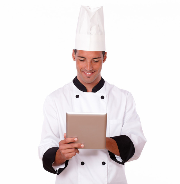 Handsome latin chef using his tablet pc - Photo, image