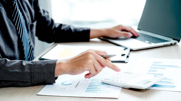 Businessman hand holding pen and analysis the chart at the home office for setting challenging business goals And planning to achieve the new target. - Photo, Image