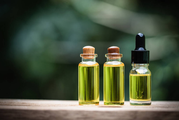 Glass bottles containing  hemp oil,  drugs extracted CBD Cannabis Oil  of researchers or medical team. Herbal alternative medicine. - Foto, imagen