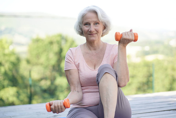 Portrait of senior woman doing fitness exercises - Foto, Imagem
