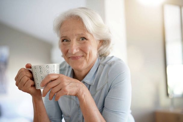 Portrait of smiling senior woman with white hair - Фото, зображення