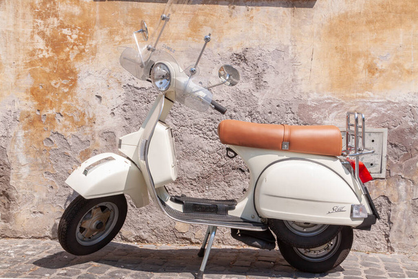 Rome, Italy - June 28, 2010: A retro, vintage motorcycle, a symbol of contemporary urban culture and lifestyle in Rome, is parked in a central street. - Φωτογραφία, εικόνα