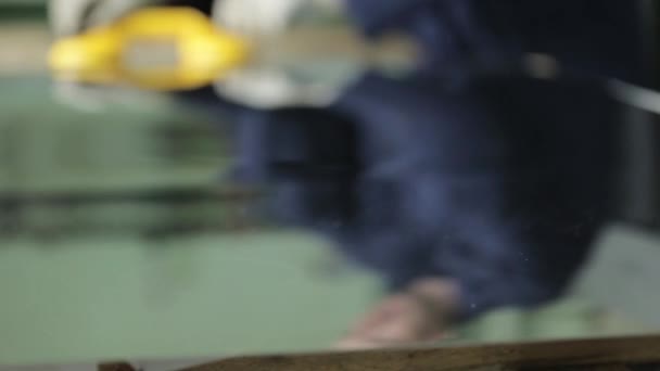 robotnik stawia żółty uchwyt ze ssaniem na blasze aluminiowej - Materiał filmowy, wideo