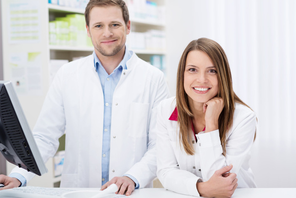 Two confident pharmacists at work - Foto, Imagen