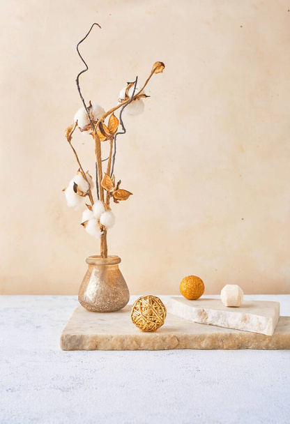 Contemporary still life with tree branch in wase, balls of different sizes, and marble board in poudre colors. Vertical image with copy space - 写真・画像