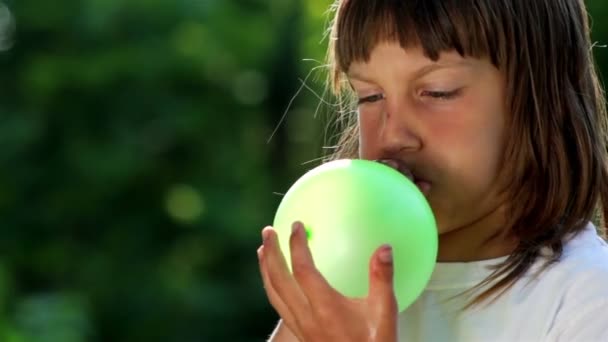 Boy inflates the balloon, portrait - Filmati, video
