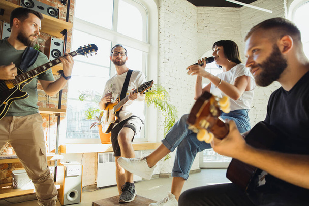 Musician band jamming together in art workplace with instruments - Foto, Imagem