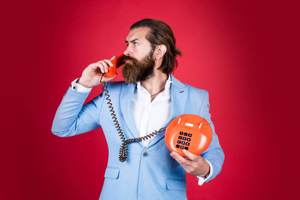 Carry your business with you. man talking to vintage phone. bearded man in suit hold retro phone. stay connected. customer service concept. Bearded man with telephone handset. business call concept - Fotografie, Obrázek