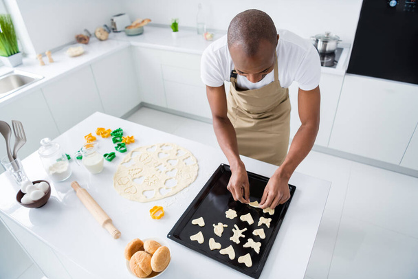 Top above high angle view of his he nice attractive guy preparing craft handmade handicraft snack pie cake cookies learning courses in modern light white interior house kitchen - Fotó, kép