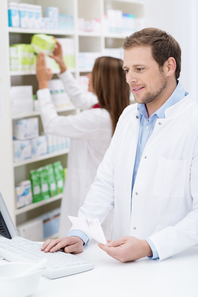 Pharmacist checking a prescription - 写真・画像