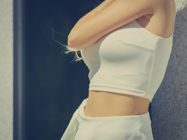 Unrecognizable fashionable woman wearing high fashion short white crop top during summer weather. - Fotografie, Obrázek