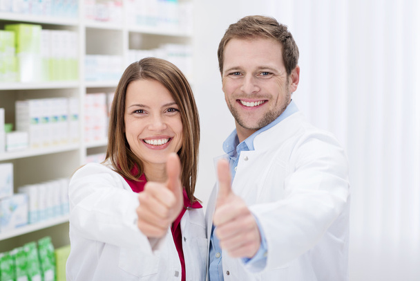 Motivated pharmacists giving a thumbs up - Photo, image