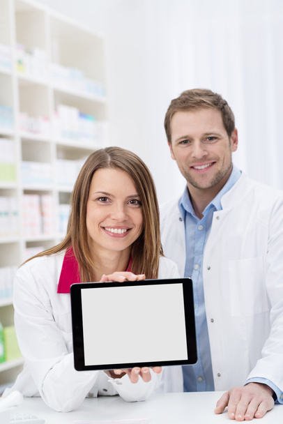 Female pharmacist displaying a blank tablet - Foto, Imagem