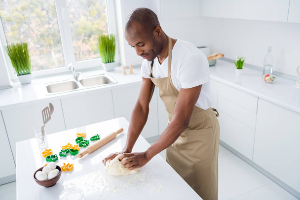 Profile side view portrait of nice attractive focused guy specialist making fresh handmade bread pie pide doughing flour spending free time weekend hobby in modern light white interior house kitchen - Zdjęcie, obraz