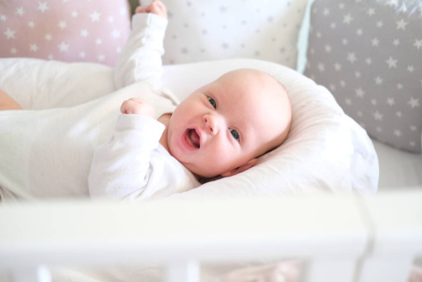 pretty newborn baby lying on the bed portrait of a cute little baby lying - Фото, зображення