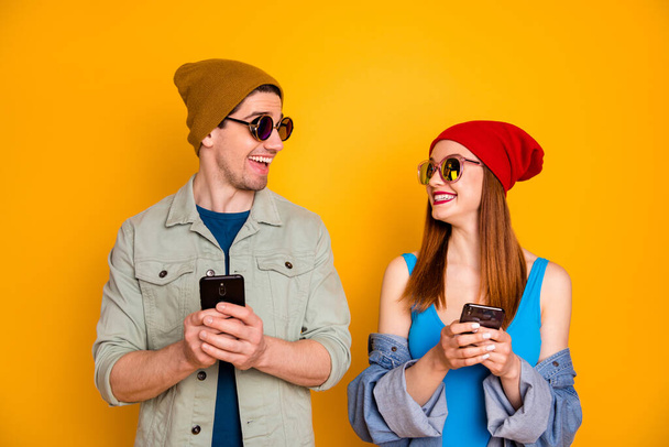 Portrait of his he her she nice attractive lovely pretty glad cheerful cheery couple using device 5g app chatting free time roaming isolated over bright vivid shine vibrant yellow color background - 写真・画像