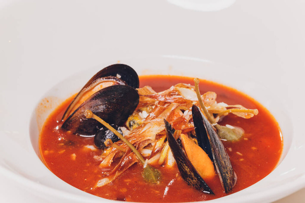 Delicious Mediterranean style tomato seafood soup with a variety of mixed seafood. - Fotoğraf, Görsel