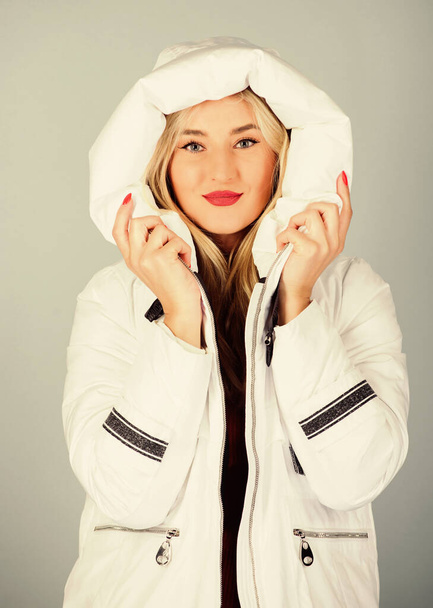 Fancy winter clothes. Not every jacket is ideal for every climate. Girl wear white jacket. Jacket has extra insulation and slightly longer fit in order to protect your body from sharp winter weather - Фото, изображение