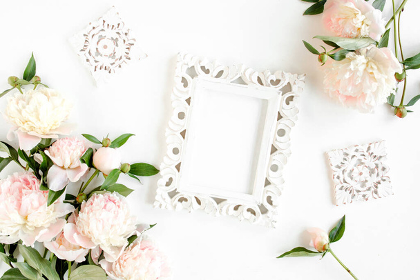 Carved, white frame decorated of beautiful pink peonies on white background. Flat lay, top view. Valentines background. Floral frame. Peony texture. - Фото, изображение