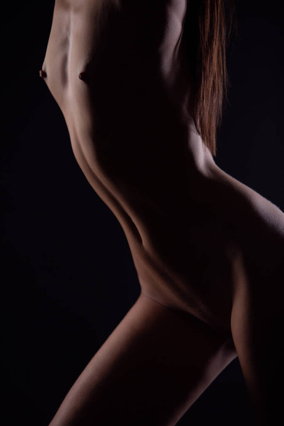 Perfect profile of a naked female body. Sexy body of a naked woman. - 写真・画像