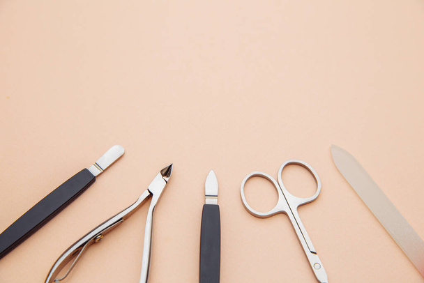 Tools of a manicure set on a pink background. Close-up. Nail and beauty care concept - Foto, imagen