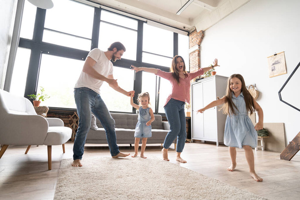happy family mother father and child daughter dancing at home. - Foto, Imagem