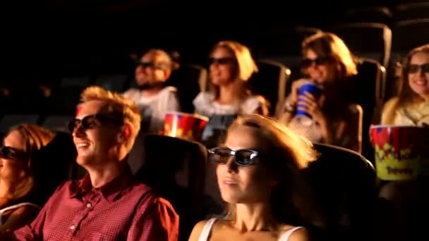 A group of excited young attractive happy male female friends enjoying 3d 4d action movie theater cinema eating popcorn - Footage, Video