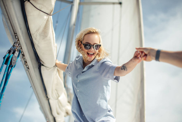 Young caucasian woman enjoying journey on yacht deck sailing the sea. - Valokuva, kuva