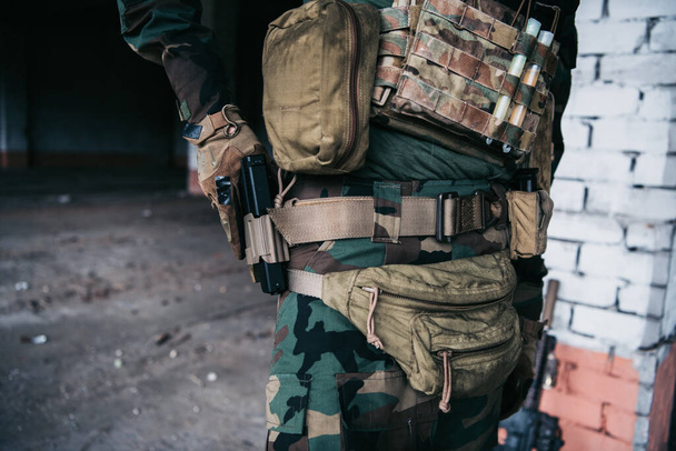 Soldier preparing tactical gear for action battle - Foto, afbeelding