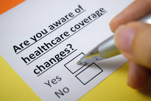 A person is answering question about healthcare coverage changes. - Photo, Image