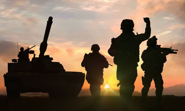 Soldiers and tank on battlefield at sunset - Photo, Image