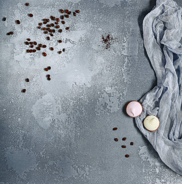 Coffee seed with sweet food top view. Coffee beans and cream pitcher flat lay on grey cement surface. - Zdjęcie, obraz