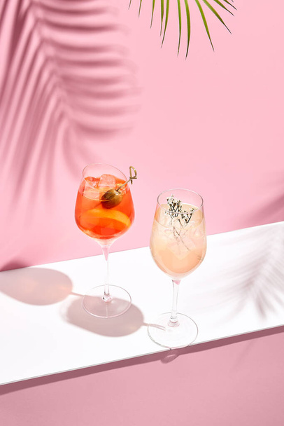Aperol Spritz Cocktail on pink background. Sunlight and shadow background. Pink and white minimal - Photo, image