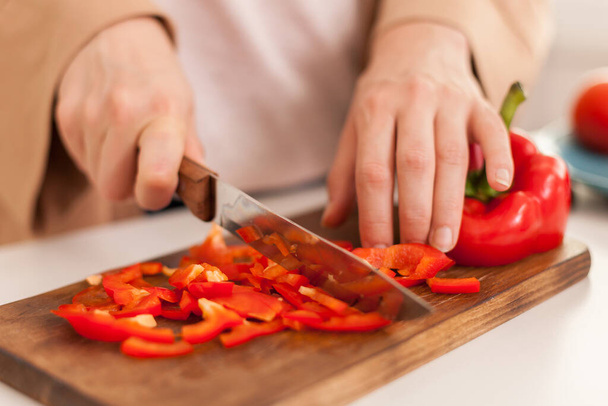 Woman cutting bell pepper - 写真・画像