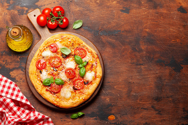 Tasty homemade pizza with garden tomatoes and basil. Top view with copy space. Flat lay - Photo, Image