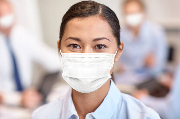 businesswoman in face protective mask at office - Foto, immagini