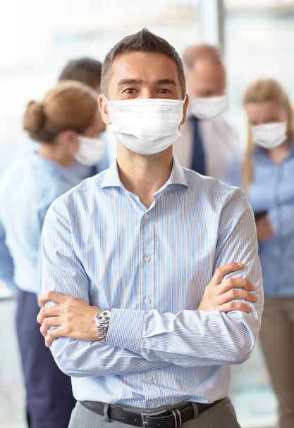 businessman wearing face protective mask at office - Fotó, kép