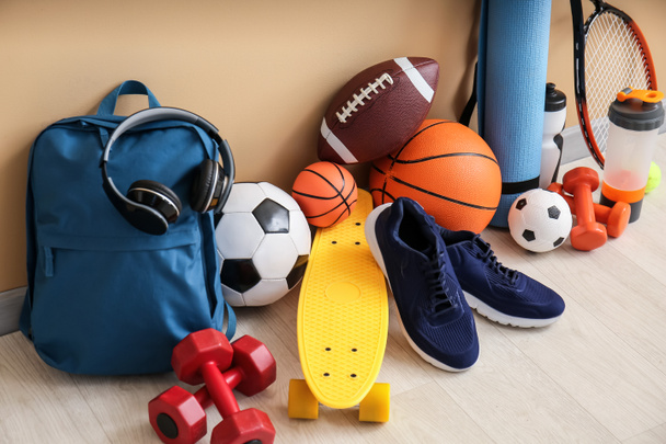 Set of sport equipment on floor near color wall - Photo, Image