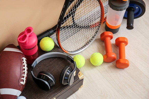 Set of sport equipment on floor near color wall - Photo, Image