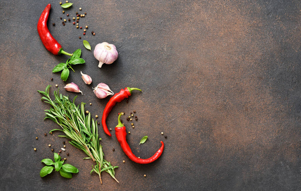 Set of spices, garlic, fresh basil and chili on a concrete background. View from above. - Photo, image