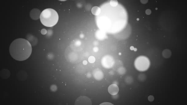 Abstraktní černobílé pozadí pohybu bokeh se zářícími částicemi koule a přidaným filmovým zrnem. Full HD a smyčka. - Záběry, video