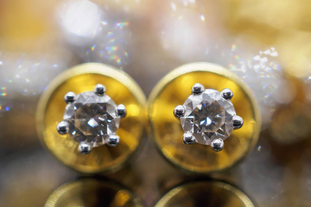 Бриллиантовые серьги из золота класса люкс с отражением на черном фоне - Фото, изображение