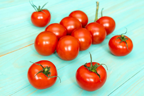 Cherry tomatoes on blue wooden background - Фото, зображення