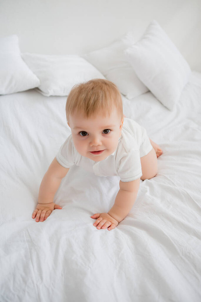 Cute happy little toddler boy laying in bed  - Foto, immagini
