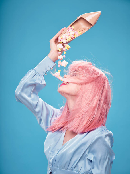 Woman with pink hair female shoe sweets candy enjoyment  - Foto, imagen