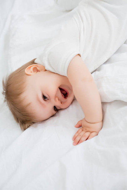 Adorable retrato de bebé niño en camisa blanca sobre fondo blanco - Foto, Imagen