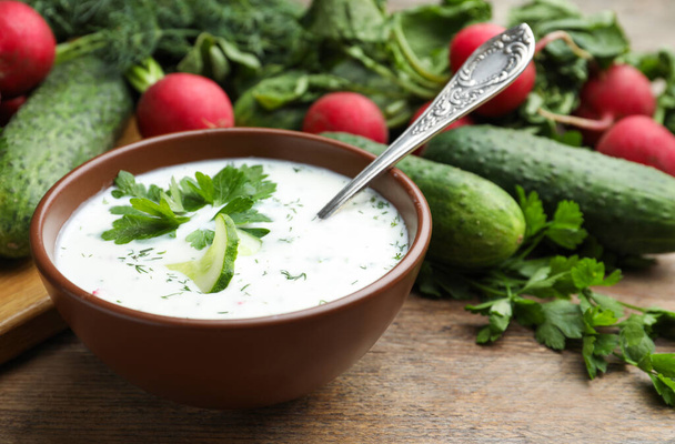 Delicious cold summer soup with kefir served on wooden table - Φωτογραφία, εικόνα