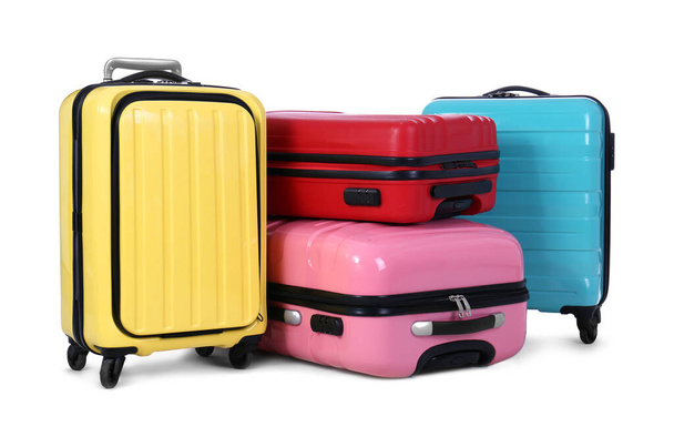 Stylish suitcases packed for travel on white background. Summer vacation - Фото, зображення