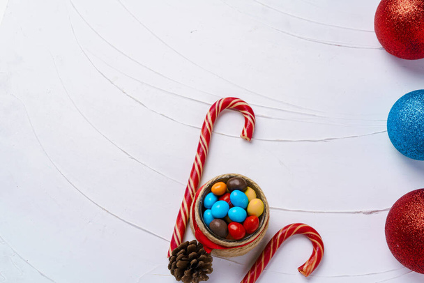 Festive background with candy canes and Christmas baubles - Fotoğraf, Görsel