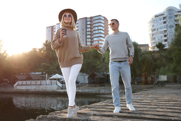 Couple in stylish sweaters on city pier - Fotó, kép